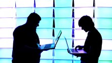  Participant hold their laptops in front of an illuminated wall at the annual Chaos Computer Club (CCC) computer hackers' congress, called 29C3, on December 28, 2012 in Hamburg, Germany. 