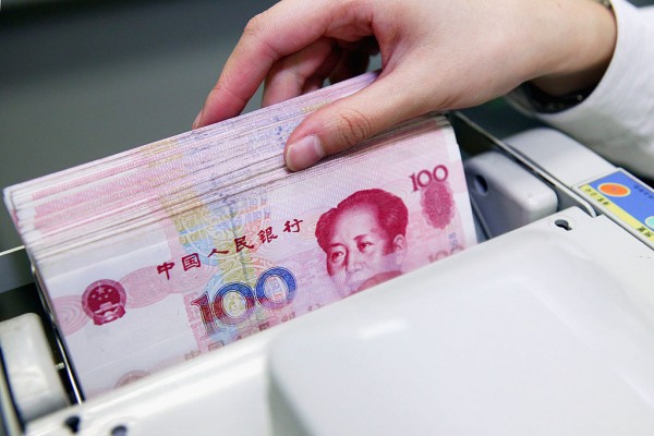A clerk counts stacks of Chinese yuan at a bank on July 22, 2005 in Shanghai, China.