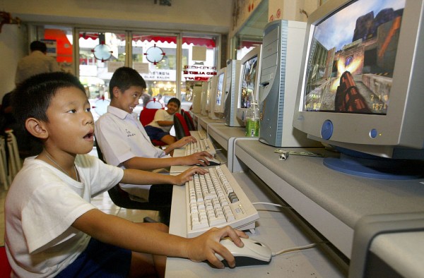 Thai youngsters play in a cyber game shop on July 16, 2003 in Bangkok, Thailand.