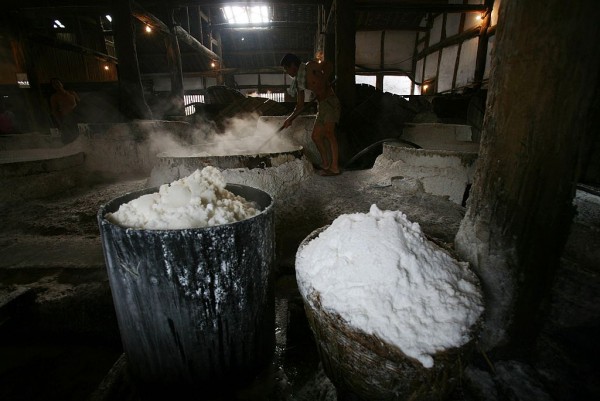  A worker adds bittern into a boiler at the Shenhai Salt Well on October 3, 2007 in Zigong of Sichuan Province, China. 