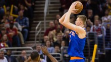 New York Knicks power forward Kristaps Porzingis (R) shoots over Cleveland Cavaliers' Tristan Thompson