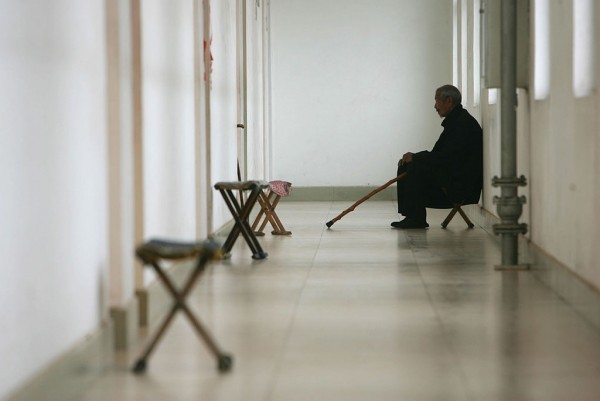  A senior citizen sits at the corridor of a care center on May 22, 2007 in Zibo of Shandong Province, China.
