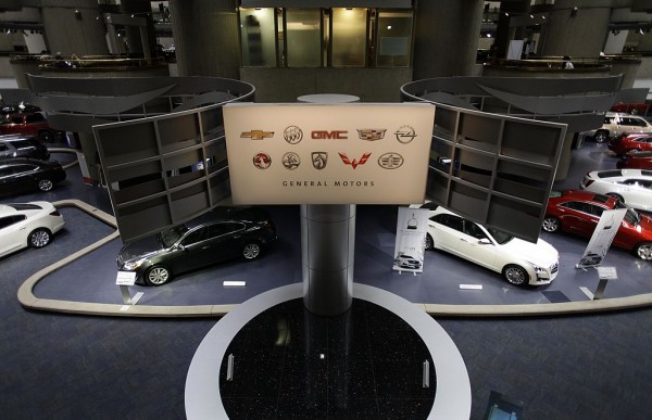 A sign is displayed with General Motors vehicles at their headquarters April 1, 2014 in Detroit, Michigan. 