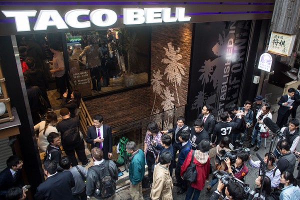 People wait outside the new Taco Bell store ahead of it's official opening on April 21, 2015 in Tokyo, Japan.