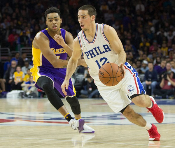 Philadelphia 76ers point guard TJ McConnell (R) drives past Los Angeles Lakers' D'Angelo Russell