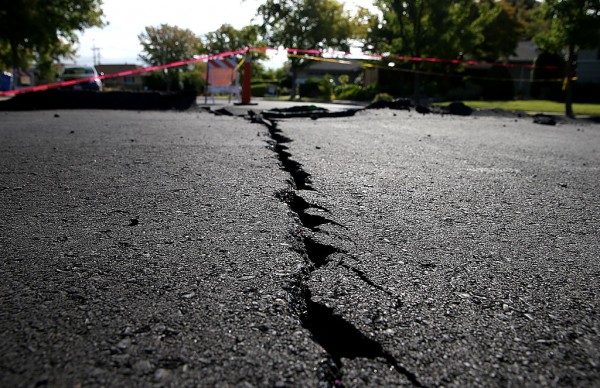  A crack runs down the center of an earthquake-damaged street on August 26, 2014 in Napa, California.