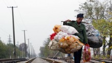  A Chinese migrant worker carrying rubbish walks on a railway December 6, 2004 in Wuhan, Hubei Province of China.