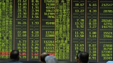  An investor observes the stock market at an exchange hall on August 21, 2015 in Hangzhou, Zhejiang Province of China. 