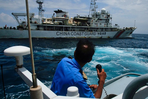 A member of the Malaysian Navy makes a call as their ship approaches a ship belonging to the Chinese Coast Guard during an exchange of communication in the South China Sea on March 15, 2014 in Kuantan, Malaysia. 