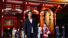 In this handout image provided by British Airways, Orlando Bloom takes in the atmosphere with British Airways ambassadors at Hozomon, inside Tokyo's Senso-Ji temple on August 19, 2016 in Tokyo, Japan. 