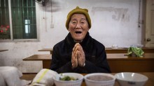  Elderly Chinese villager Hong Meizi, 83, prays before a meal at the Ji Xiang Temple and nursing home on March 17, 2016 in Sha County, Fujian province, China. 