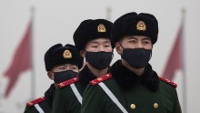  Chinese Paramilitary police wear masks to protect against pollution, a rare occurrence, as they march during smog in Tiananmen Square on December 9, 2015 in Beijing, China. 