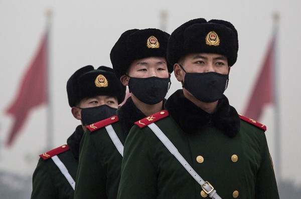  Chinese Paramilitary police wear masks to protect against pollution, a rare occurrence, as they march during smog in Tiananmen Square on December 9, 2015 in Beijing, China. 