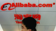 A man walks past the logo of Alibaba (China) technology Co., Lth on August 12, 2005 in Beijing, China. 