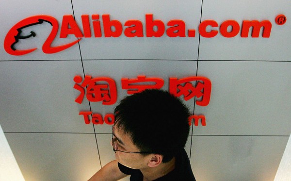 A man walks past the logo of Alibaba (China) technology Co., Lth on August 12, 2005 in Beijing, China. 
