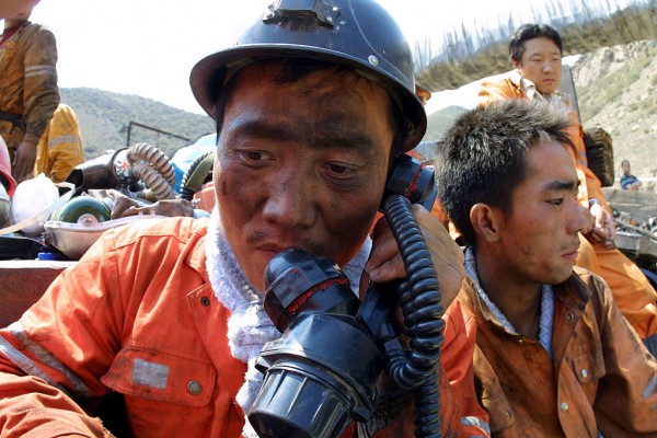 Chinese rescuers rest after a rescue mission at the Shenlong Coal Mine July 11, 2005 in Fukang County of Xinjiang Uygur Autonomous Region, northwest China.