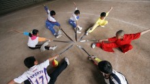 Children practice Kung Fu at a Martial Arts School.