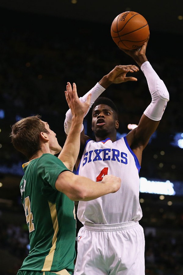 Philadelphia 76ers center Nerlens Noel (R) takes a shot over Boston Celtics' Tyler Zeller