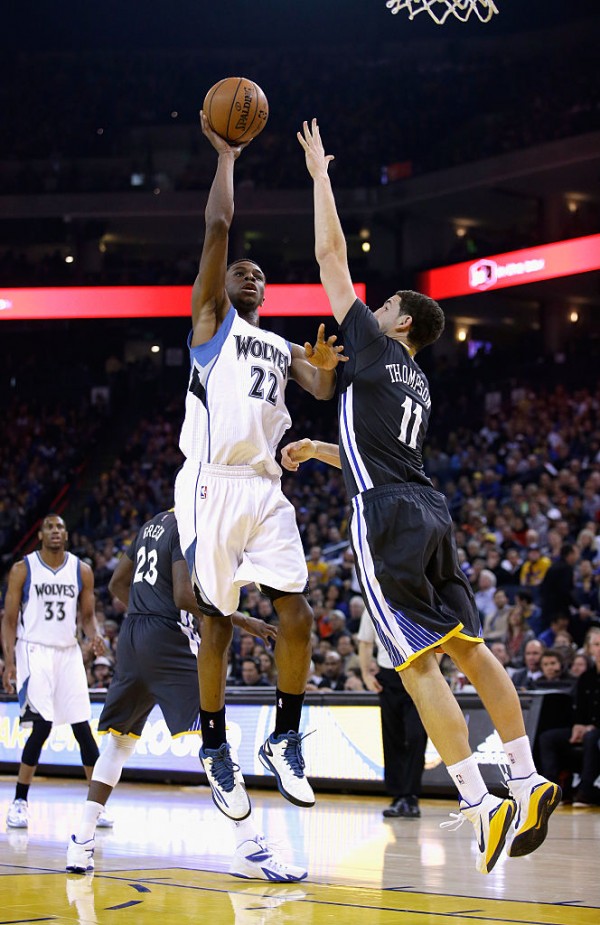 Minnesota Timberwolves forward Andrew Wiggins (L) shoots over Golden State Warriors' Klay Thompson