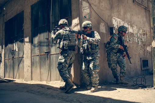 U.S army troops advance a position in combat